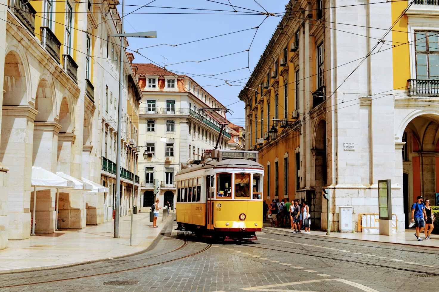 Tram 28 climbing a narrow street in Alfama, Lisbon